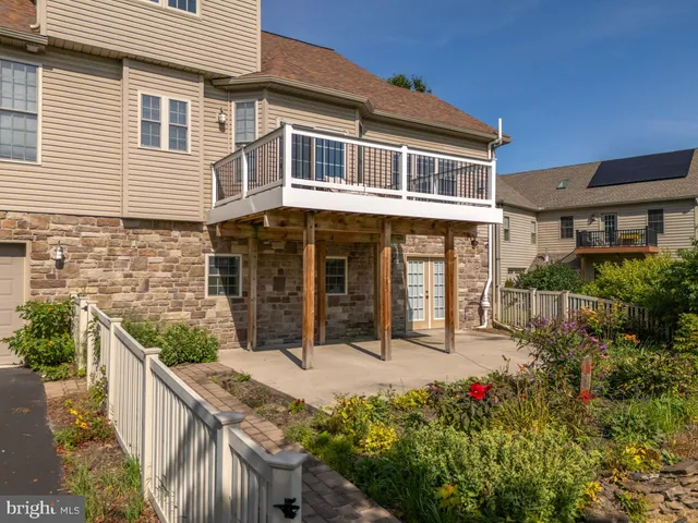 a living room with furniture a fireplace and potted plants