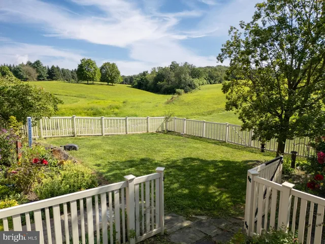 a view of a dining room with furniture wooden floor and a chandelier