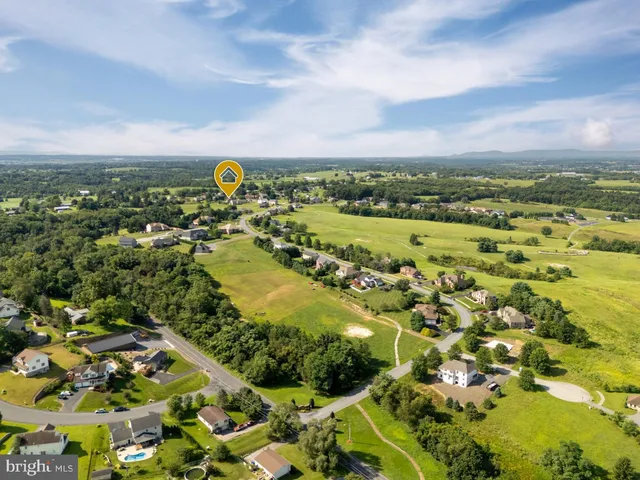 a kitchen with kitchen island granite countertop wooden floors stainless steel appliances and sink