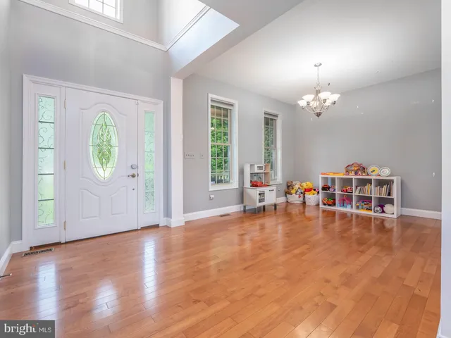 a bedroom with a large bed and a chandelier