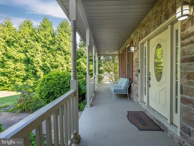 a view of a porch with furniture and garden