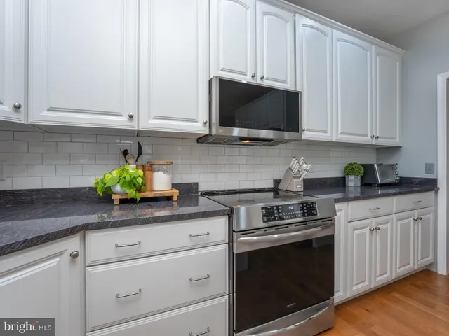 a view of a workspace with furniture and a bathroom