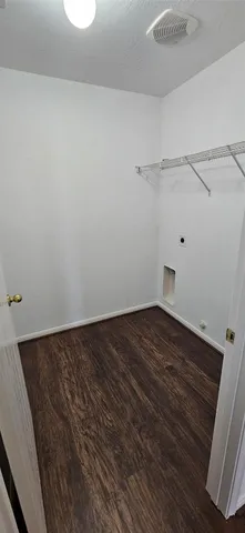 a view of a room with wooden floor