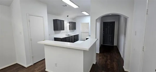 a kitchen with a sink and refrigerator