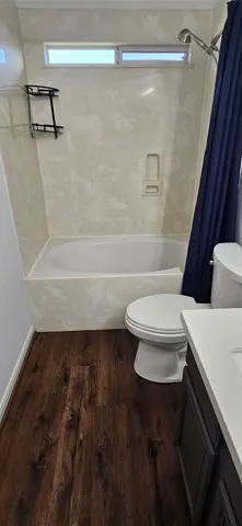 a bathroom with a toilet and a shower