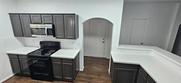 a kitchen with a sink cabinets and stainless steel appliances