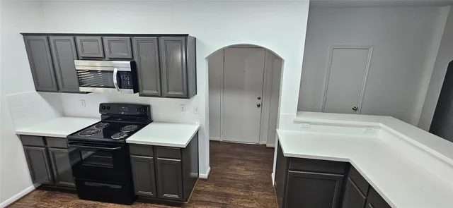 a kitchen with a sink cabinets and stainless steel appliances