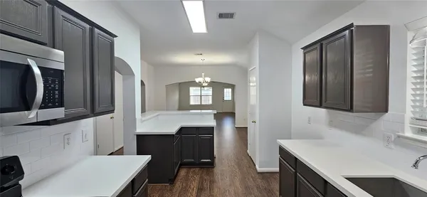a bathroom with a sink a toilet a mirror and vanity