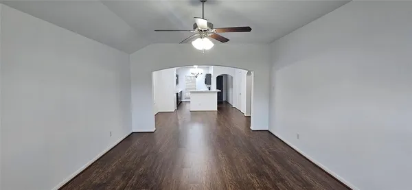 a view of a room with wooden floor chandelier and a window