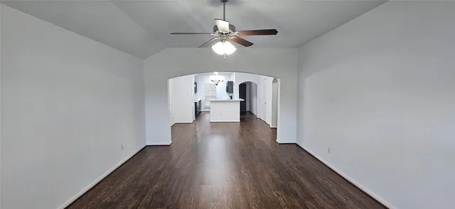 a view of a room with wooden floor chandelier and a window