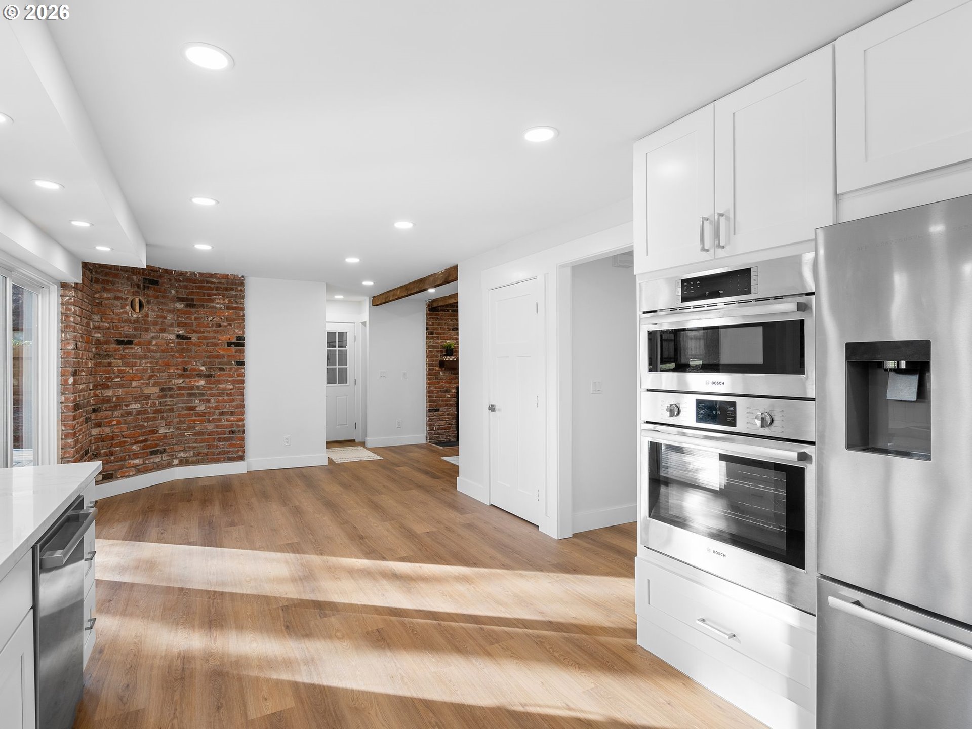 20270 Southwest Jaylee Street Beaverton, OR 97078 - Photo 12 of 40 a kitchen with stainless steel appliances kitchen island granite countertop a refrigerator oven a sink and dishwasher