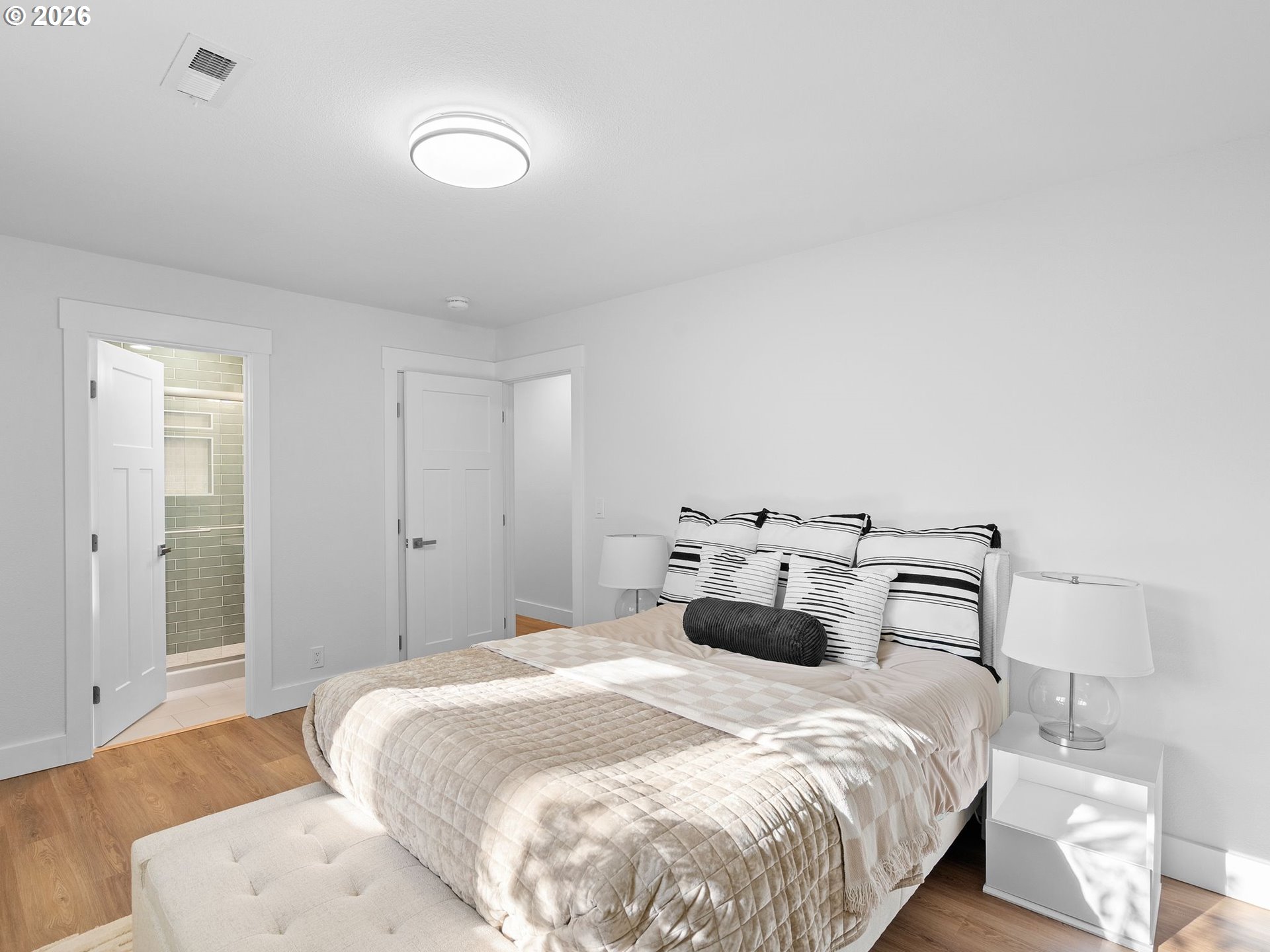 20270 Southwest Jaylee Street Beaverton, OR 97078 - Photo 22 of 40 a bedroom with a bed and lamp