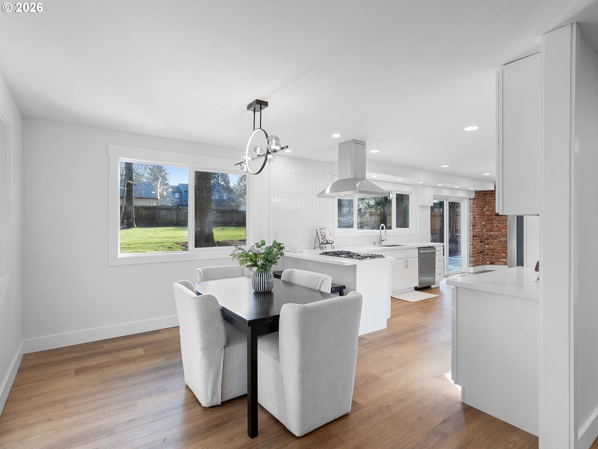 20270 Southwest Jaylee Street Beaverton, OR 97078 - Photo 8 of 40 a living room with kitchen island furniture and a wooden floor