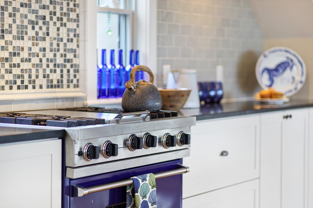 18 Snow Shore Road Orleans, MA 02653 - Photo 14 of 42 a kitchen with a stove and a white cabinet