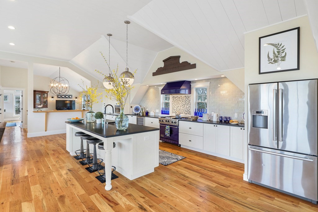 18 Snow Shore Road Orleans, MA 02653 - Photo 15 of 42 a kitchen with stainless steel appliances a stove a sink dishwasher and a refrigerator with wooden floor