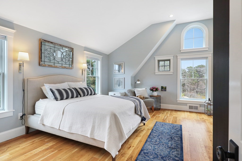 18 Snow Shore Road Orleans, MA 02653 - Photo 25 of 42 a spacious bedroom with a bed and wooden floor