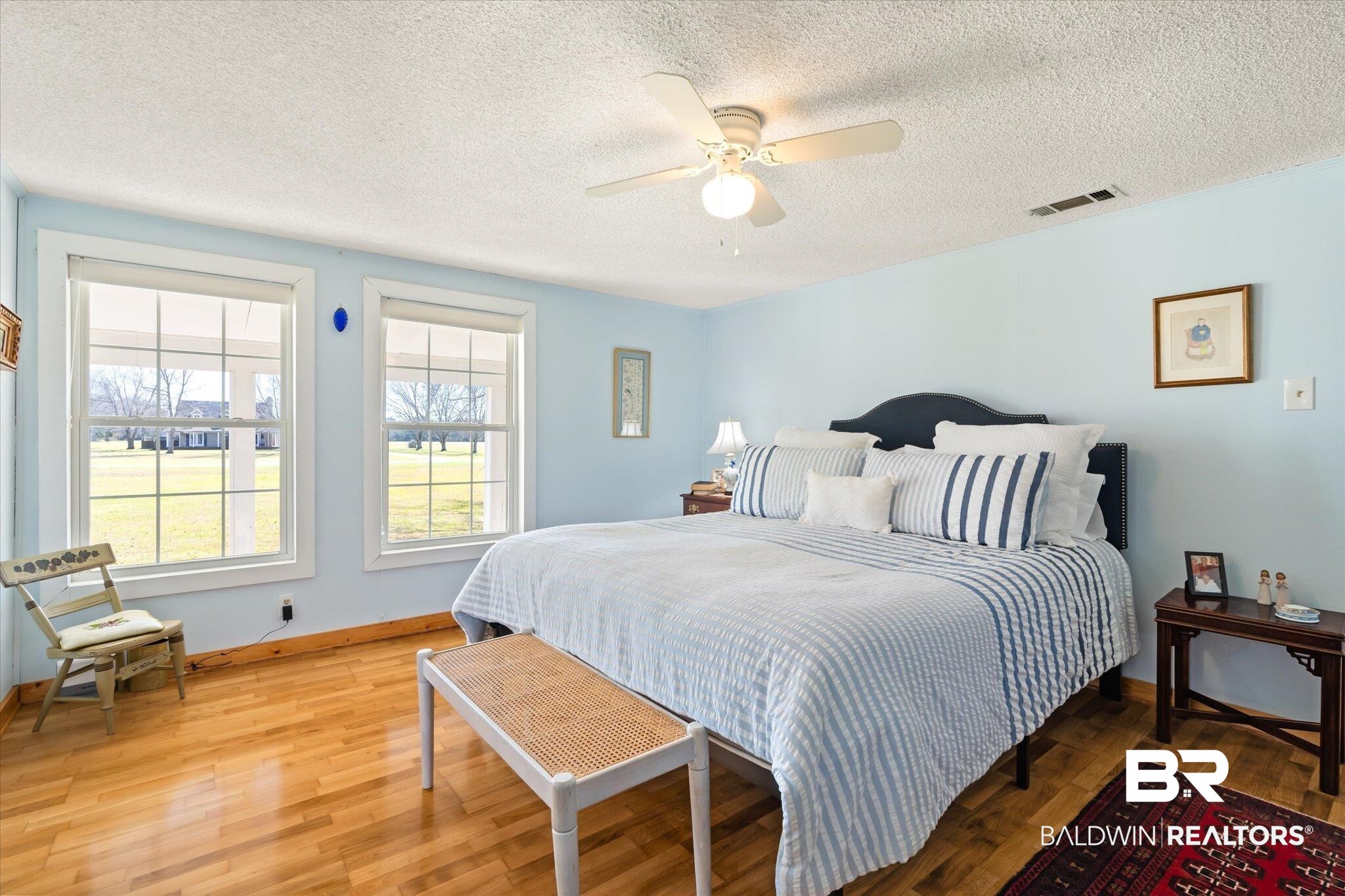 14280 Cat Deakle Road Grand Bay, AL 36541 - Photo 15 of 51 Bedroom featuring ceiling fan, light wood finished floors, visible vents, and baseboards