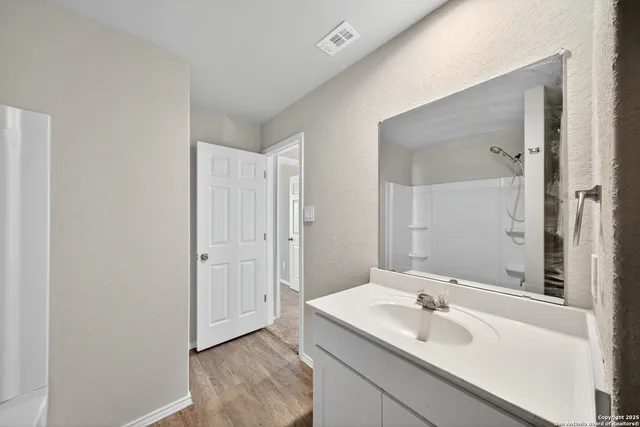 a bathroom with a sink and a mirror