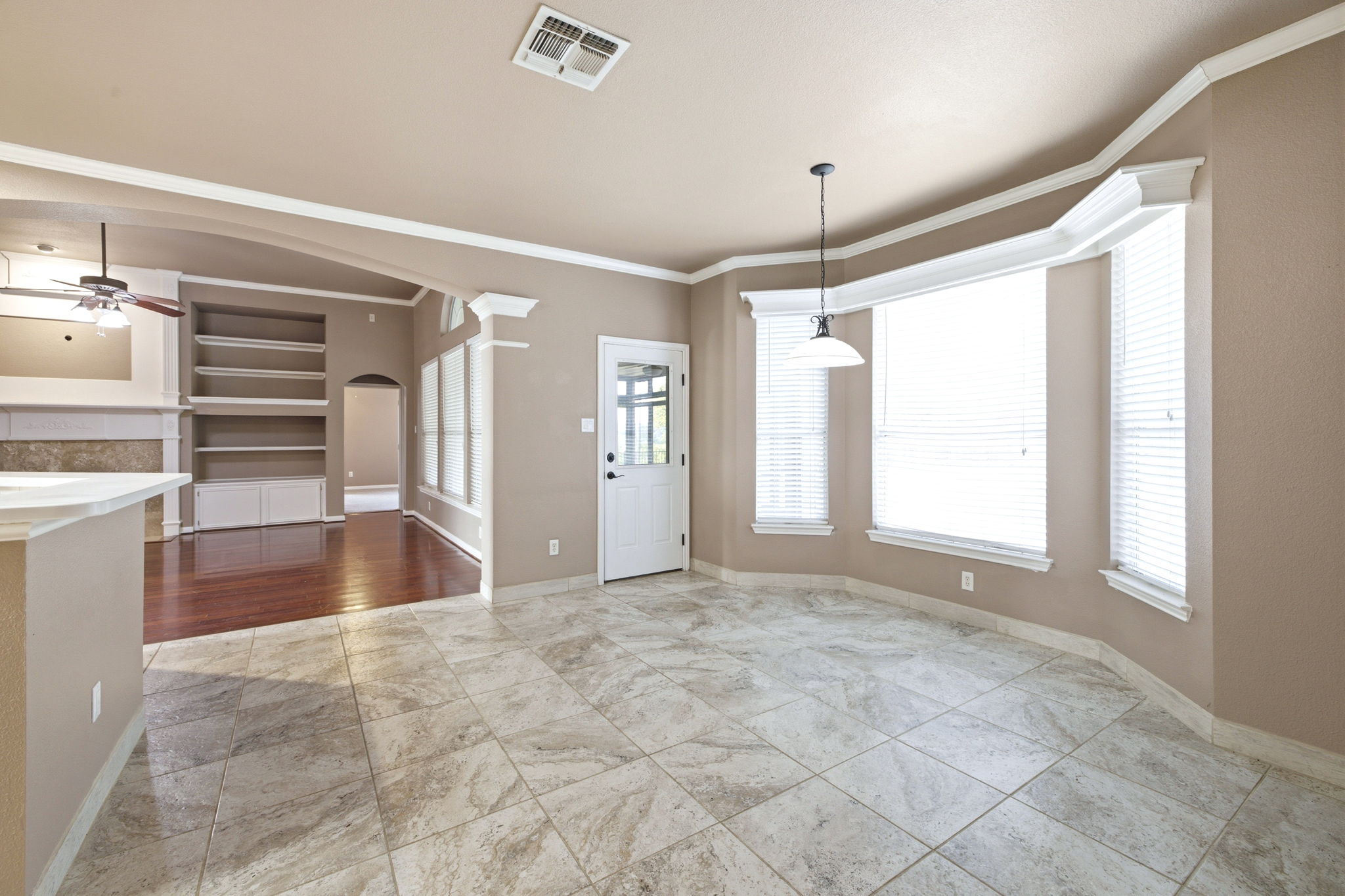 271 Rollin N Ranch Road Blanco, TX 78606 - Photo 16 of 40 A spacious, naturally illuminated room featuring a bay window, tile flooring, and elegant crown molding.