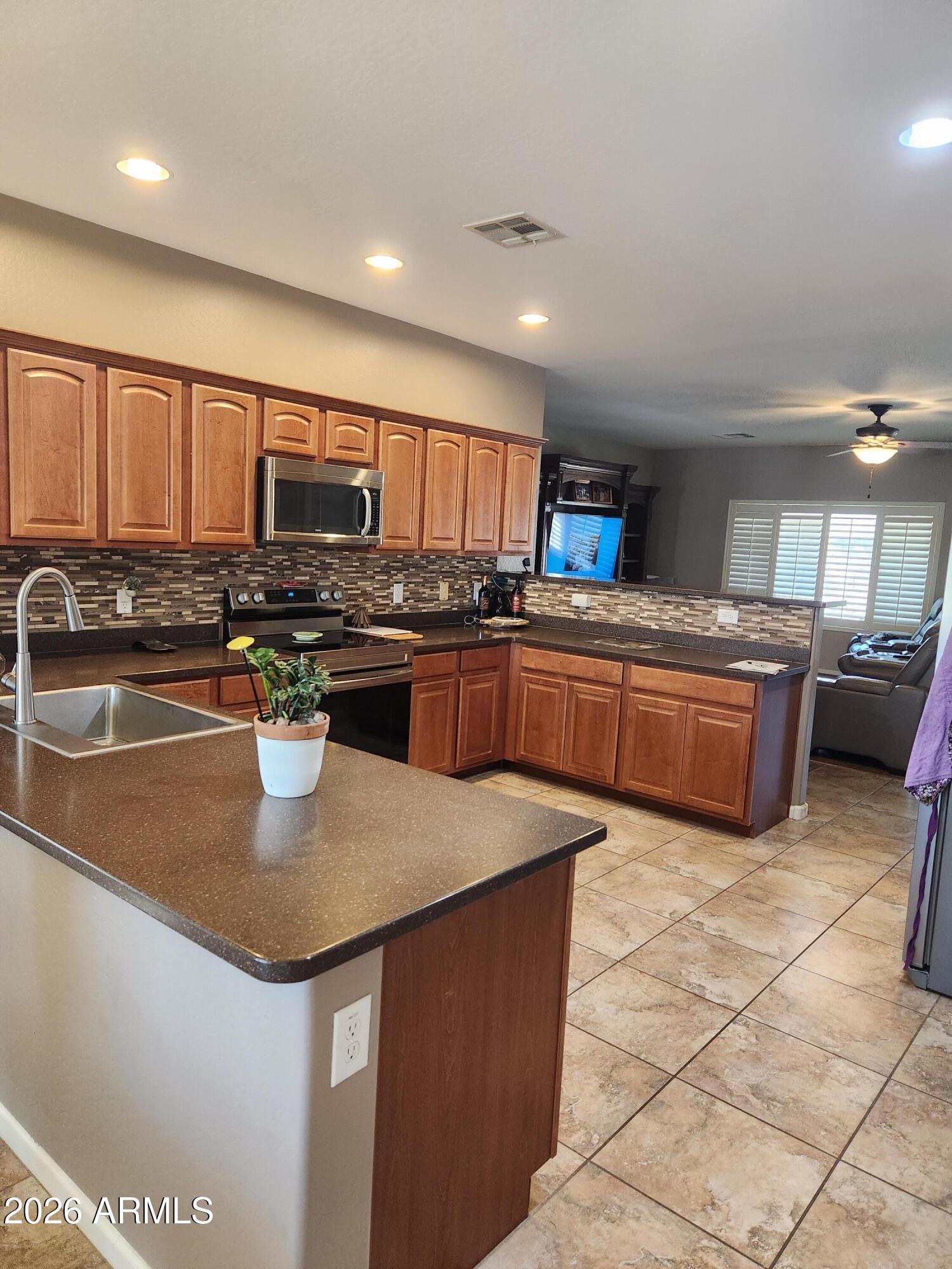 108 East Ridgeview Trail Casa Grande, AZ 85122 - Photo 3 of 38 a kitchen with stainless steel appliances granite countertop a sink a stove and a refrigerator