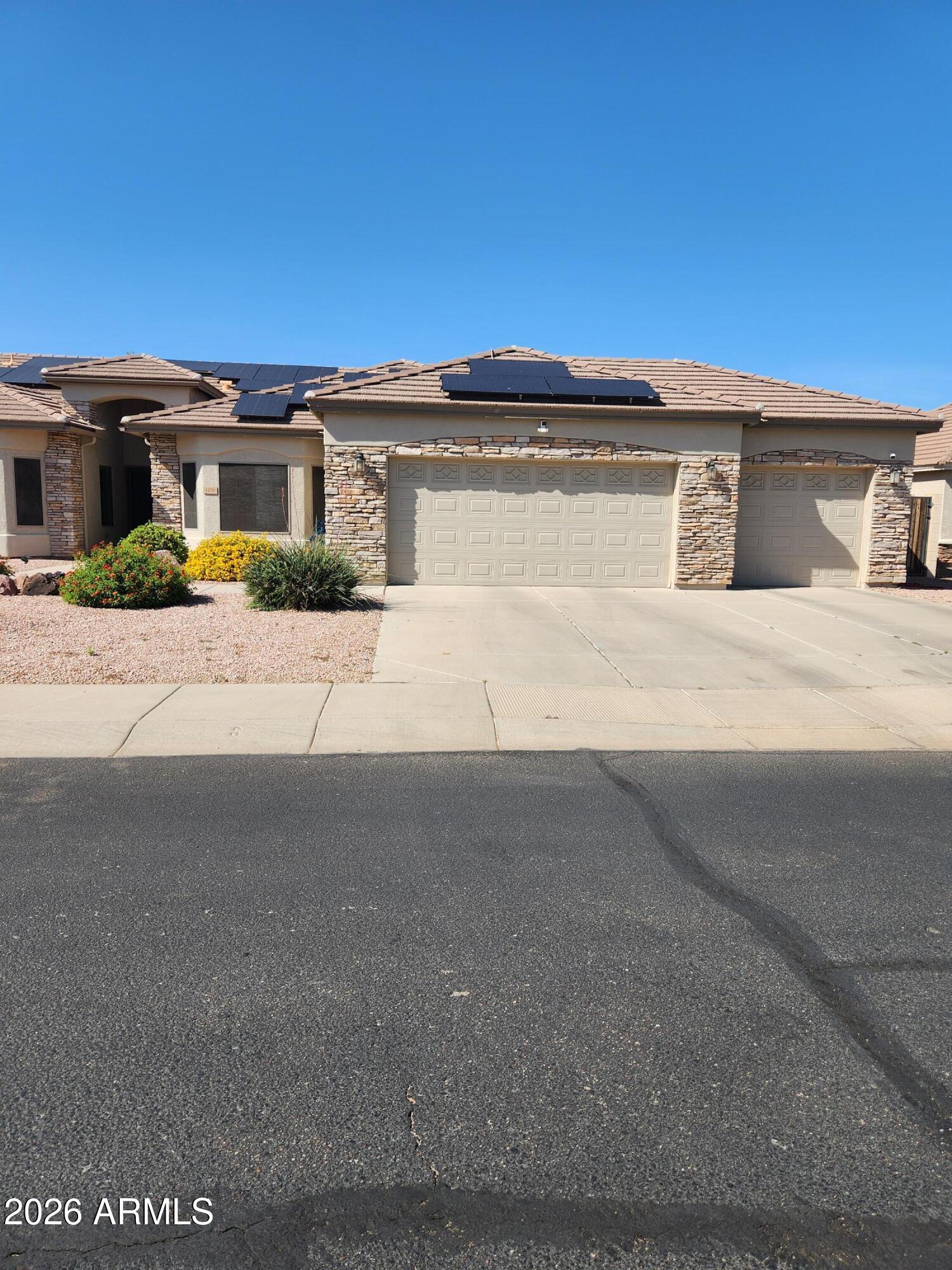 108 East Ridgeview Trail Casa Grande, AZ 85122 - Photo 33 of 38 a front view of a house with a yard and garage