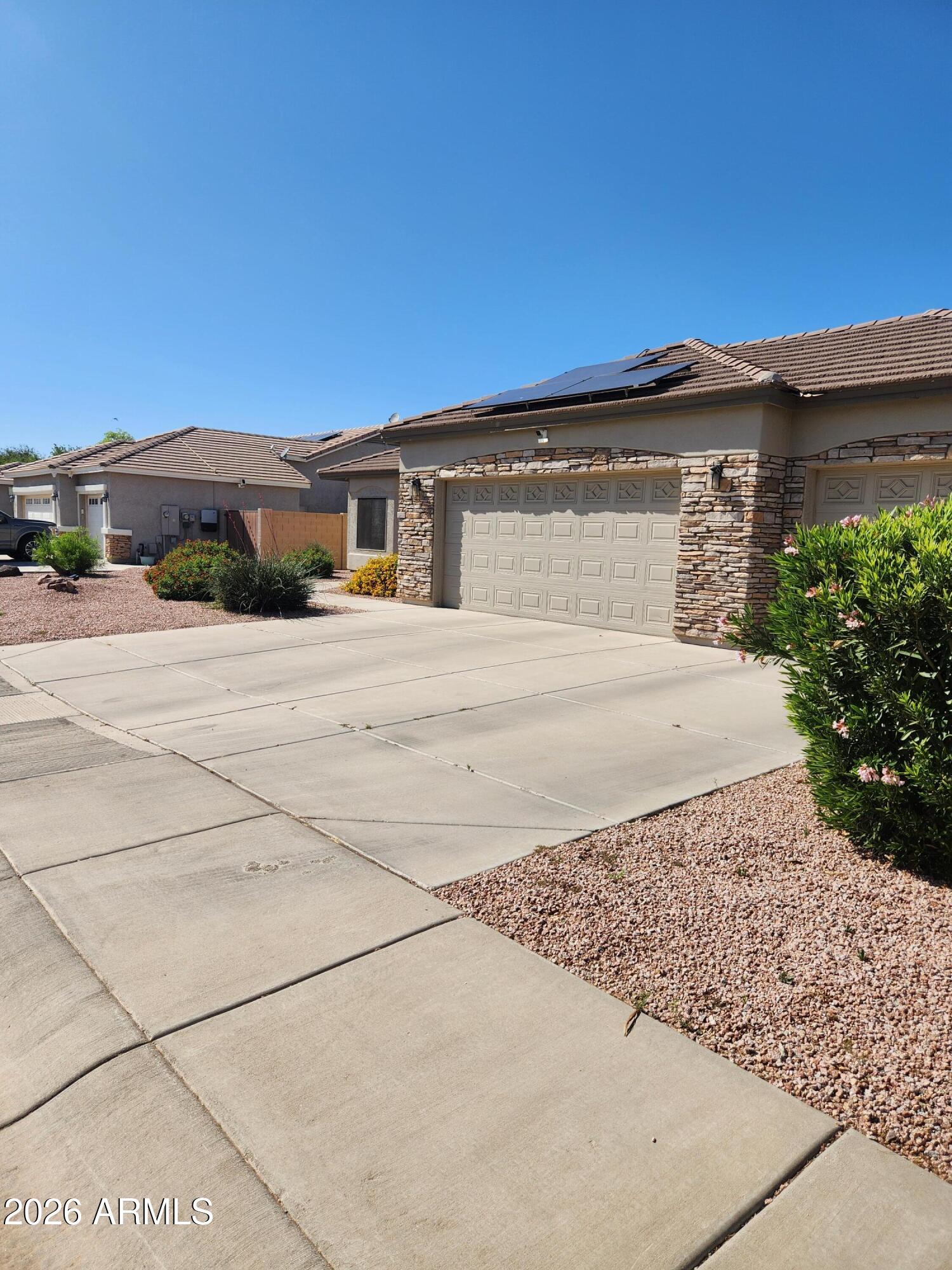 108 East Ridgeview Trail Casa Grande, AZ 85122 - Photo 35 of 38 a front view of a house with a yard and garage