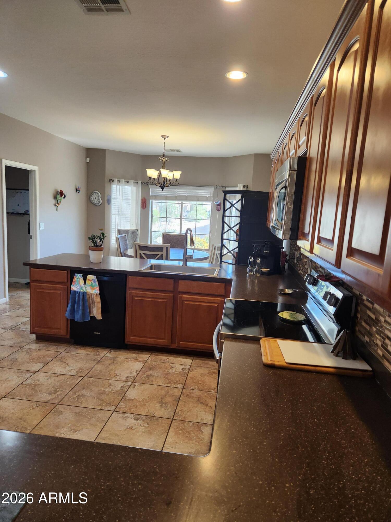 108 East Ridgeview Trail Casa Grande, AZ 85122 - Photo 6 of 38 a kitchen with stainless steel appliances granite countertop a sink counter space and a window