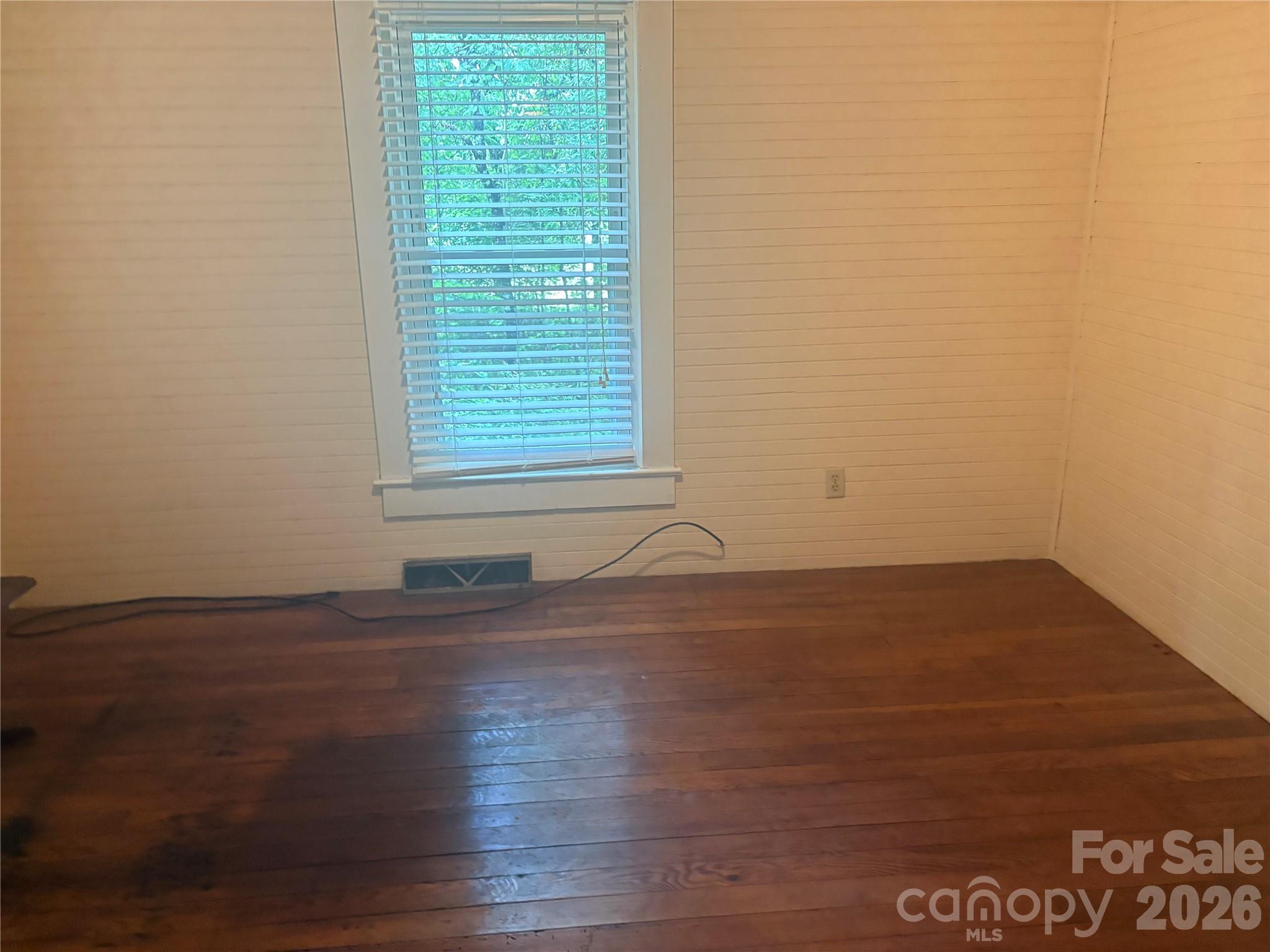 3880 Love Road Claremont, NC 28610 - Photo 6 of 14 an empty room with wooden floor and windows