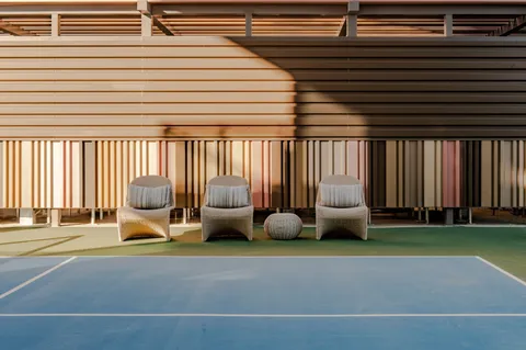 a view of a patio with a table and chairs and a barbeque