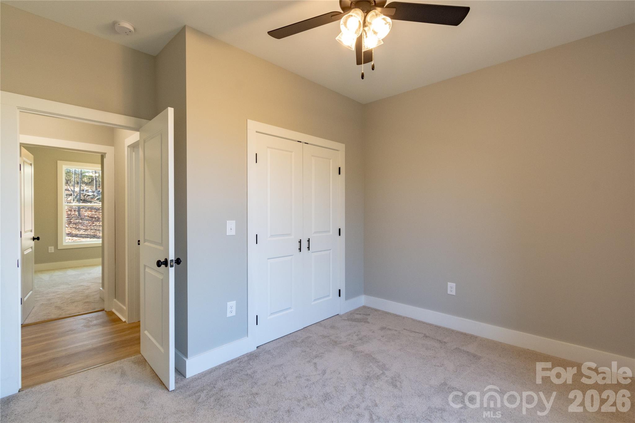 472 Oak Road Norwood, NC 28128 - Photo 12 of 27 an empty room with chandelier fan