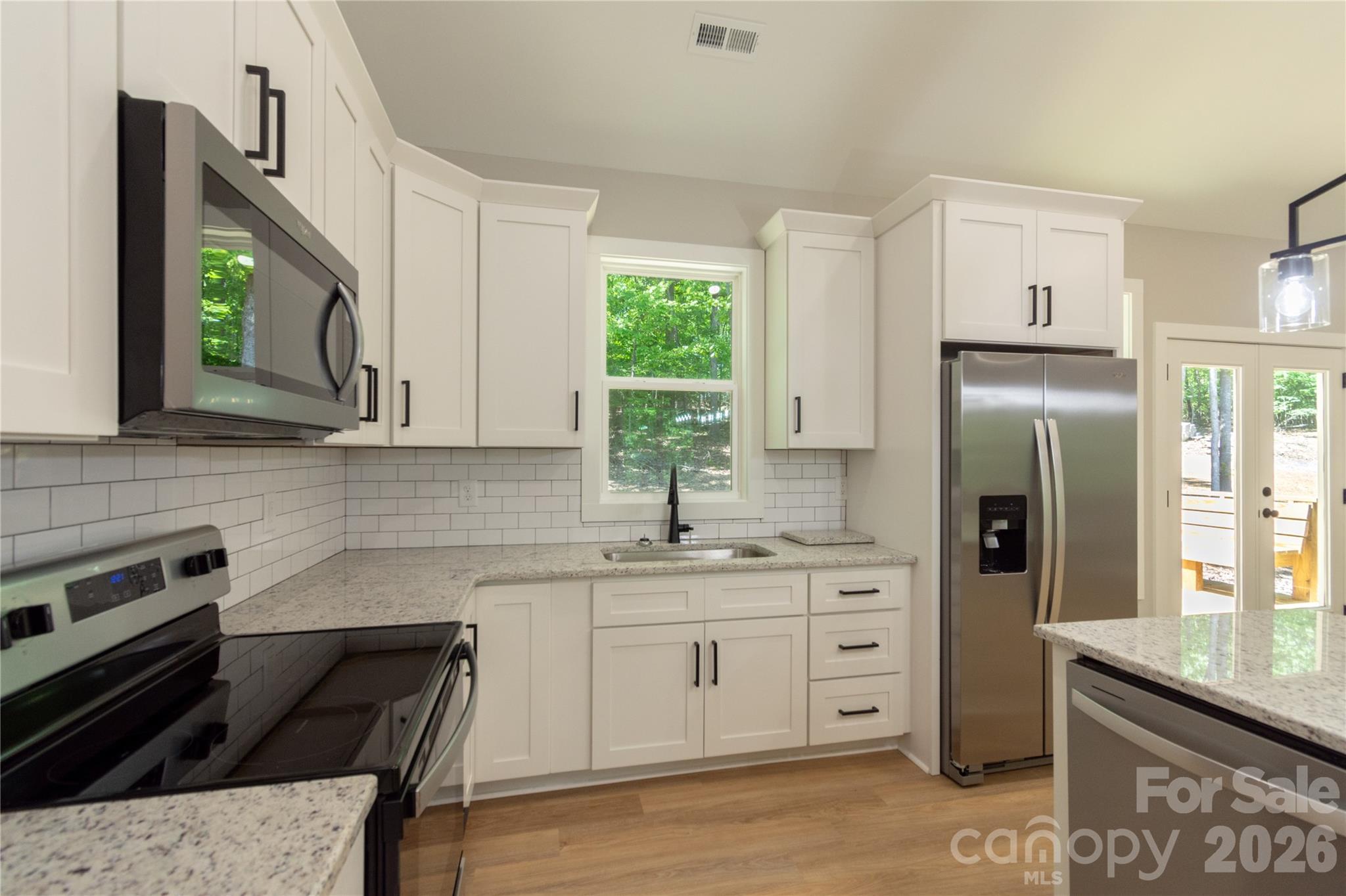 472 Oak Road Norwood, NC 28128 - Photo 8 of 27 a kitchen with a sink stove and refrigerator