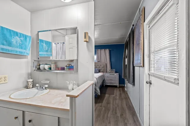 a en suite bathroom with a sink a mirror and a shower