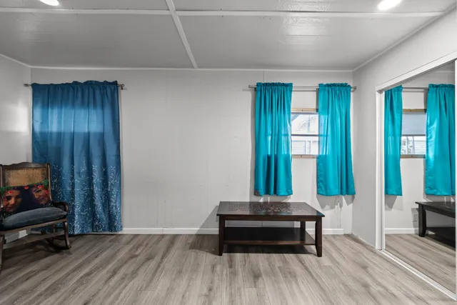 a view of a hallway to a livingroom with furniture