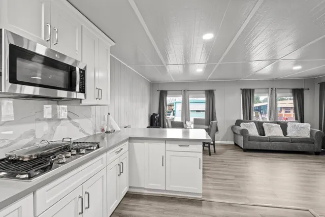 a kitchen with stainless steel appliances a stove microwave and cabinets