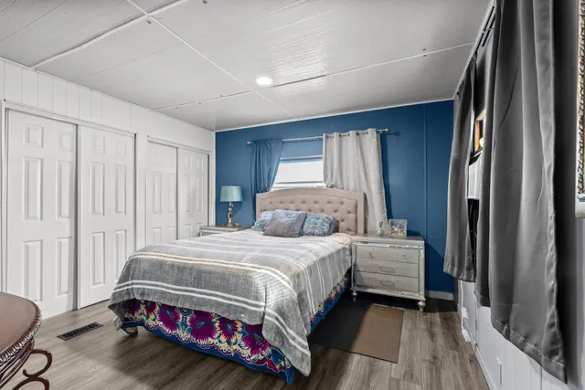 a bedroom with a bed and a mirror