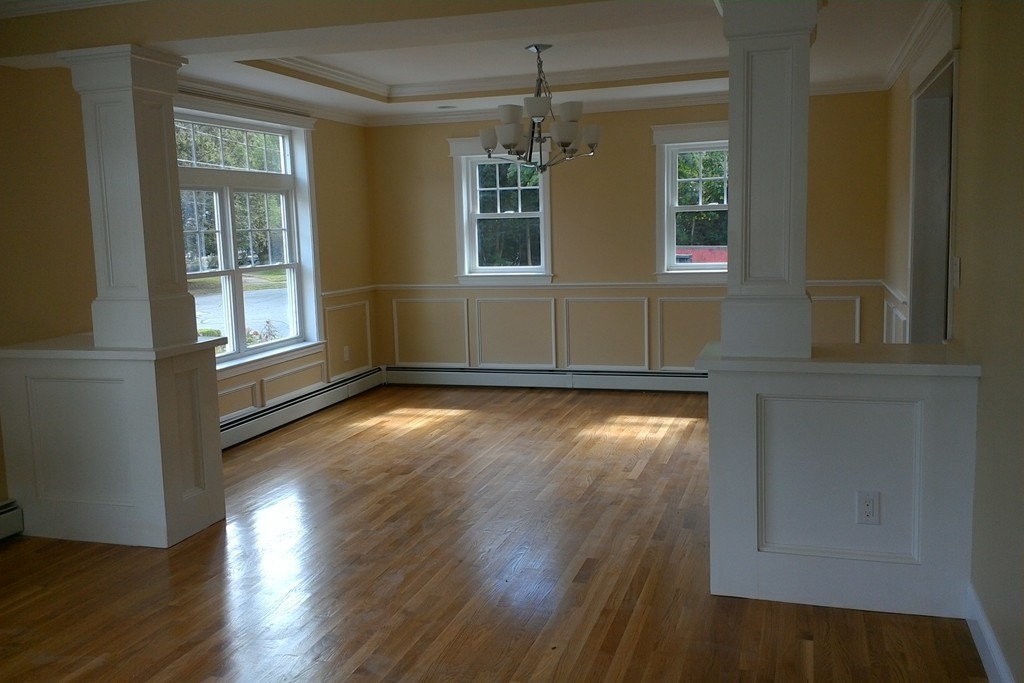 39 Dunedin Road Wellesley, MA 02481 - Photo 4 of 13 an empty room with wooden floor and windows