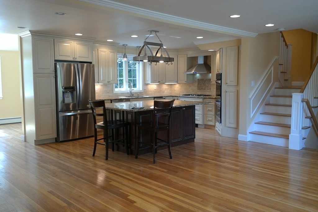 39 Dunedin Road Wellesley, MA 02481 - Photo 5 of 13 a kitchen with granite countertop a refrigerator dining table and chairs