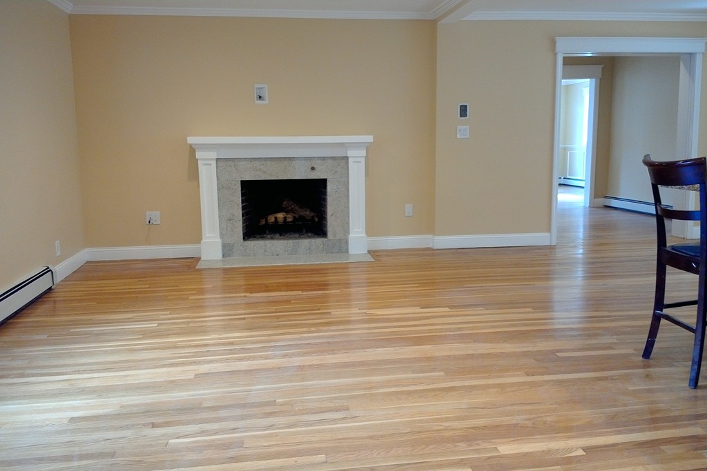 39 Dunedin Road Wellesley, MA 02481 - Photo 8 of 13 a view of an empty room with wooden floor and a fireplace
