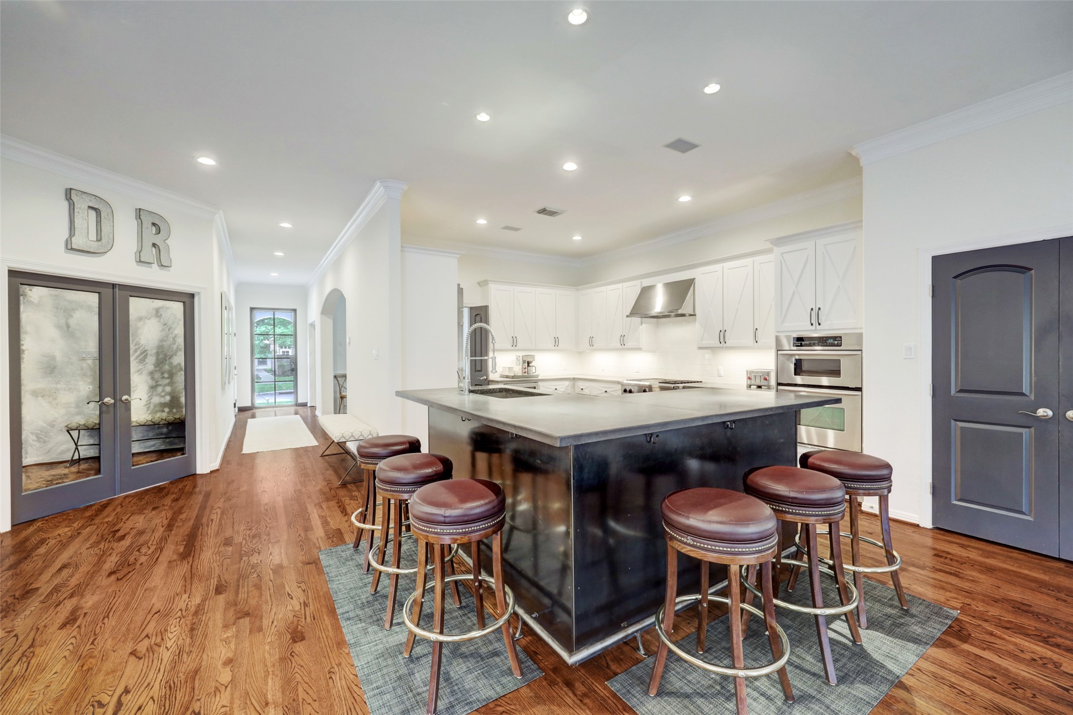 4004 Childress Street Houston, TX 77005 - Photo 17 of 34 a kitchen with a dining table chairs and white appliances