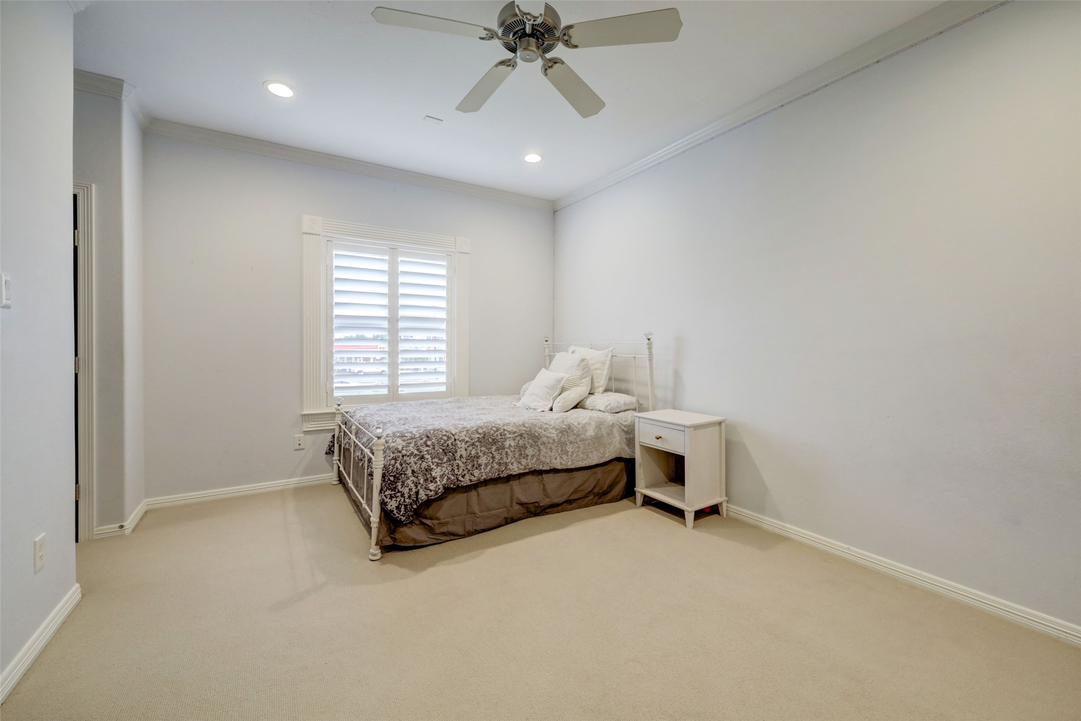 4004 Childress Street Houston, TX 77005 - Photo 21 of 34 a bedroom with a bed and a chandelier