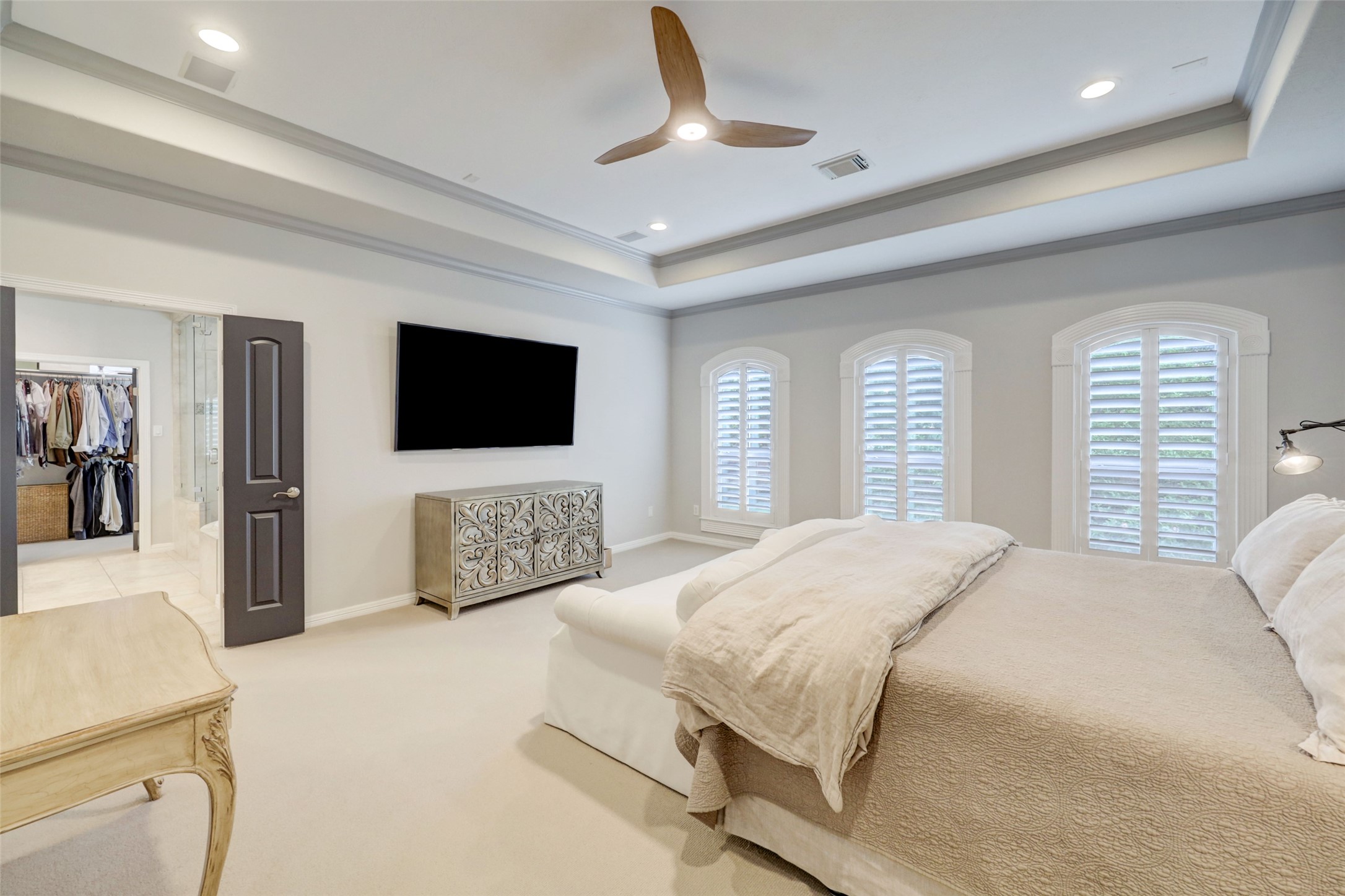 4004 Childress Street Houston, TX 77005 - Photo 24 of 34 a bedroom with a bed a mirror on dresser and a flat screen tv