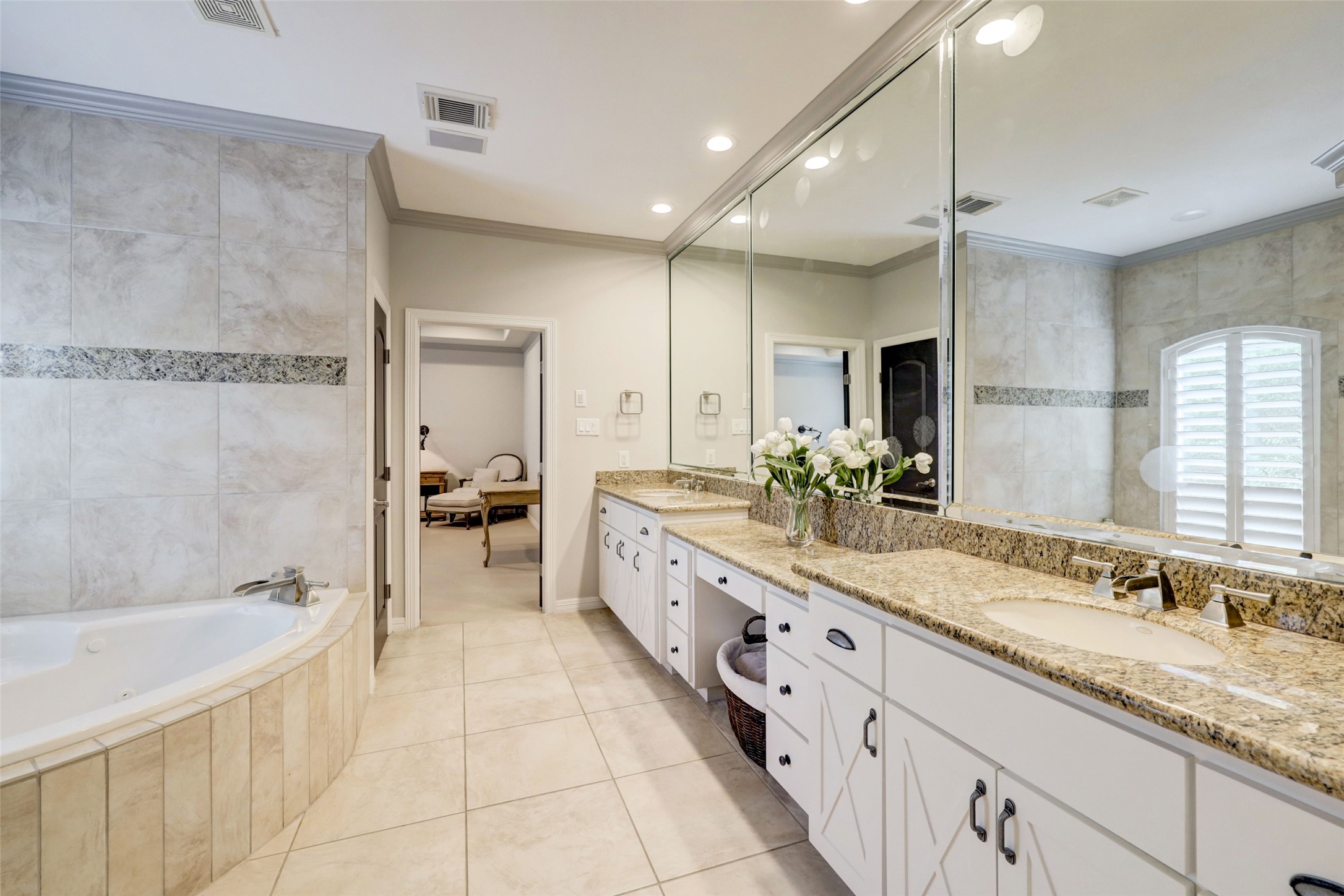 4004 Childress Street Houston, TX 77005 - Photo 25 of 34 a large bathroom with a granite countertop double vanity sink a mirror and a bathtub