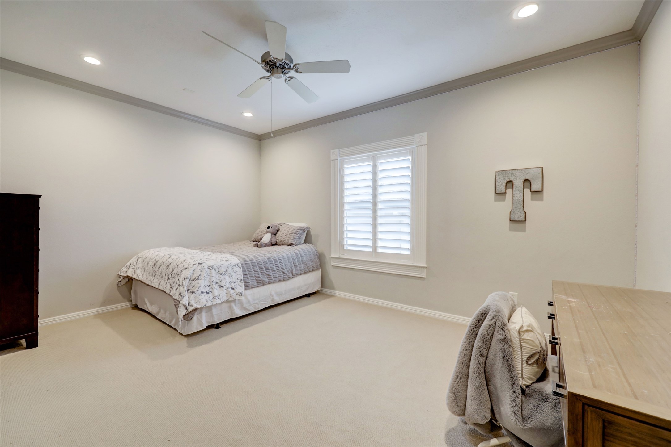 4004 Childress Street Houston, TX 77005 - Photo 29 of 34 a bedroom with a bed and a chandelier