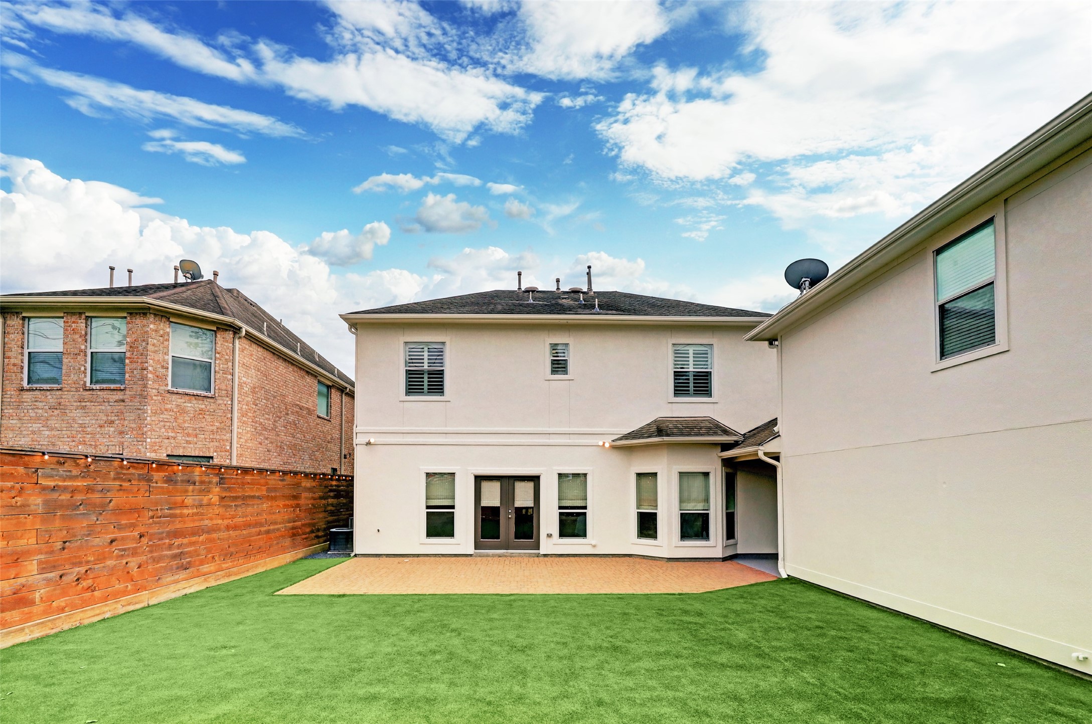 4004 Childress Street Houston, TX 77005 - Photo 34 of 34 a view of a white house with a big yard and potted plants