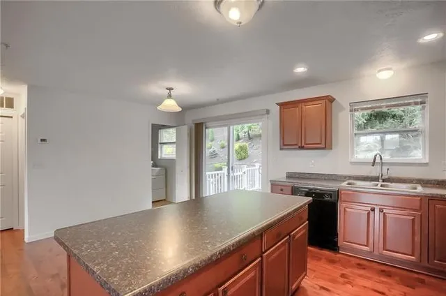 a kitchen with a stove a sink a microwave and cabinets