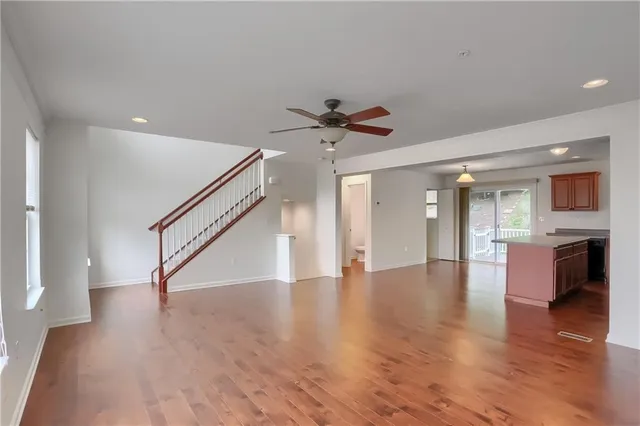 a view of an entryway with wooden floor and a kitchen