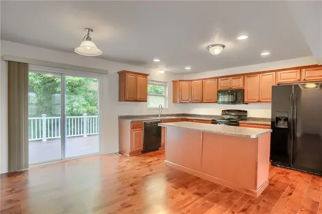 a kitchen with stainless steel appliances granite countertop a refrigerator sink and cabinets