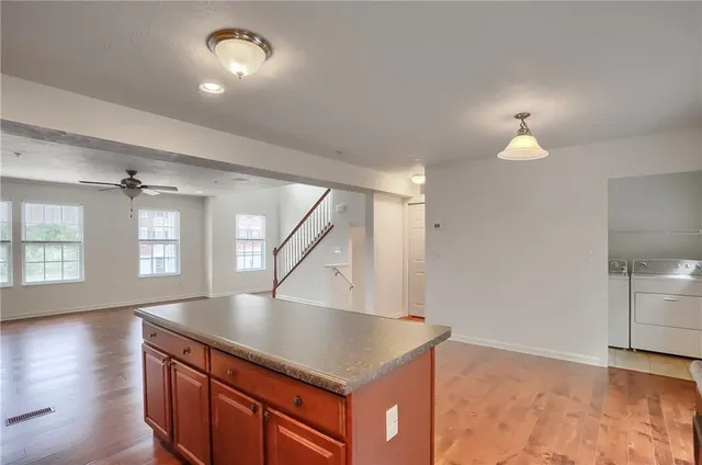 a kitchen with kitchen island a counter top space and a sink