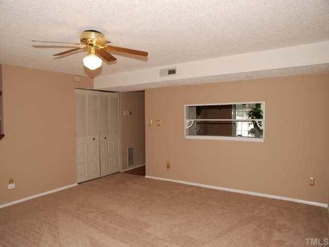 7735 Sandra Lane Raleigh, NC 27615 - Photo 3 of 8 Neutral carpet, designer neutral wall paint, ceiling fan with light, triple window, closet, 9-light door to deck