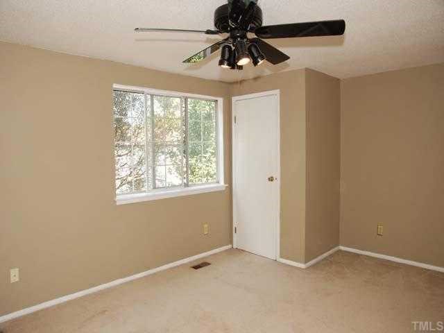 7735 Sandra Lane Raleigh, NC 27615 - Photo 5 of 8 Neutral carpet, designer neutral wall paint, ceiling fan with light, triple window, walk in closet